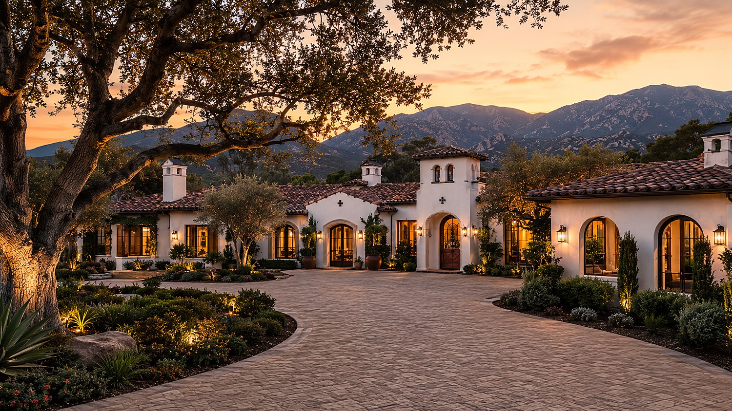 Montecito estate entry and motor court illuminated at dusk